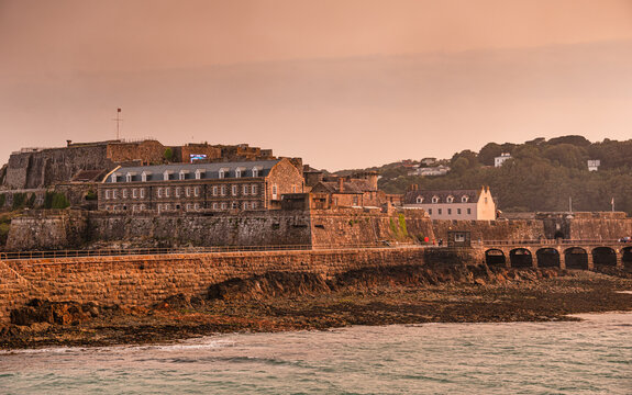 Castle Cornet shines in sunset light above the harbor at St. Peter Port in Guernsey