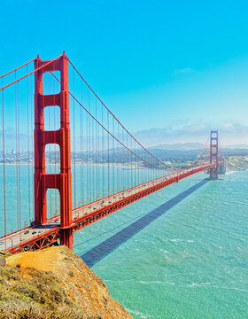 Golden Gate Bridge spans across the water in San Francisco, California on a sunny day with clear skies