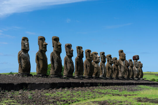 Moai statues stand in a row at Ahu Tongariki during a sunny day in Chile on Easter Island