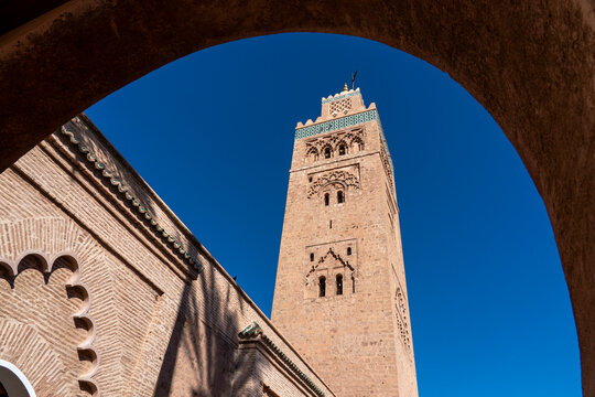 Minaret of Koutoubia Mosque stands tall against blue sky in Marrakech