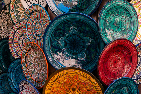 Colorful ceramic plates displayed in the souk of Marrakech showcasing local craftsmanship and artistry in Morocco
