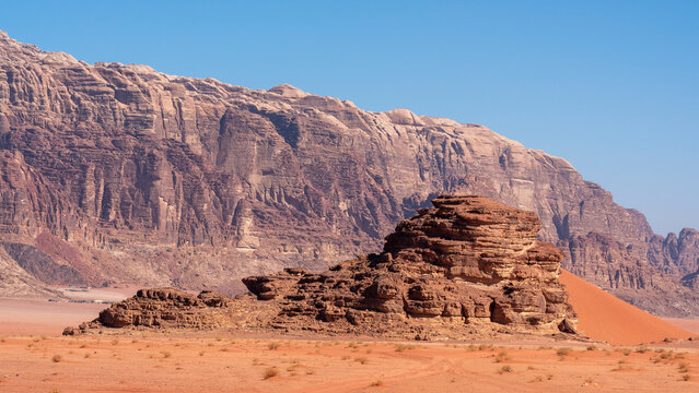 Exploring Wadi Rum desert terrain with rocky formations and bright blue sky in Jordan