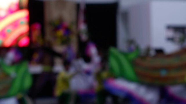 Cultural dancers in traditional costumes from nearby towns perform their practiced dance steps at a government-sponsored trade fair held in the public grounds. Blurs