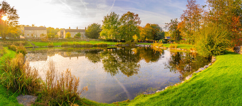 Reflections in the village pond during autumn in Monyash village, Bakewell, Derbyshire, England