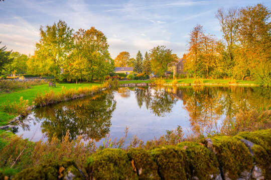 Reflections in village pond in Monyash village during autumn in Bakewell, Derbyshire Peak District, England