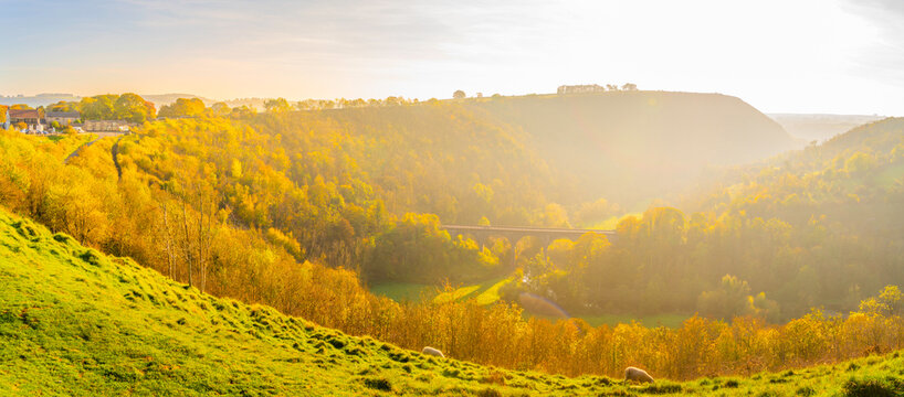 View of Monsal Dale and viaduct in autumn light over the hills near Bakewell in Derbyshire