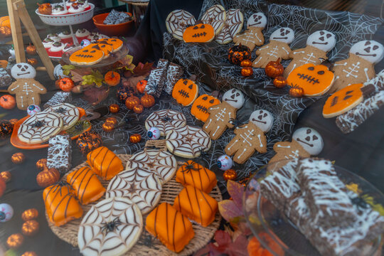 View of cake shop window filled with sweets and baked goods during autumn season in Chesterfield, Derbyshire, England, United Kingdom