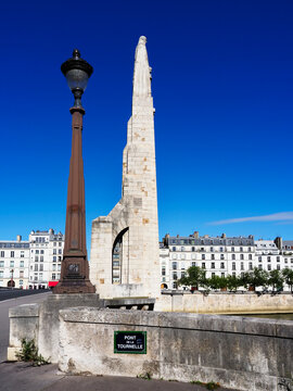 View of Pont de la Tournelle under blue sky near Ile St Louis in Paris showcasing the historic architecture and lamp post