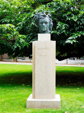 Beethoven sculpture stands in garden with green trees in background during daytime in Paris, Ile de France