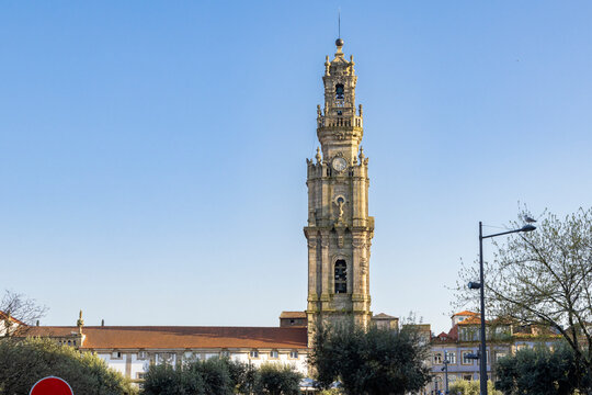 Cl&eacute;rigos Tower Porto Portugal historic landmark with blue sky and trees