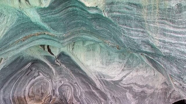 Journey through the majestic Marble Caves of Patagonia, where swirling mineral patterns create an artistic spectacle.