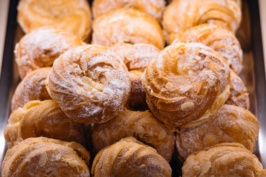 Paris-Brest choux pastries filled with praline cream displayed in showcase.