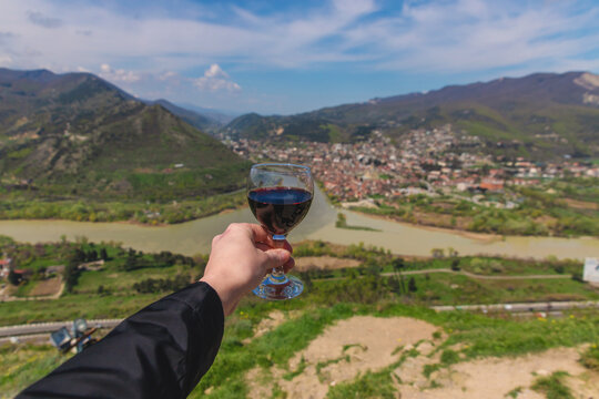 A glass of wine on the background of Georgia. Selective focus.