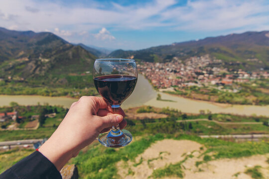 A glass of wine on the background of Georgia. Selective focus.