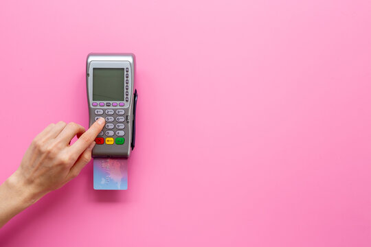 Contactless payment process - hand holding credit card near POS terminal, tap to pay, fintech transaction