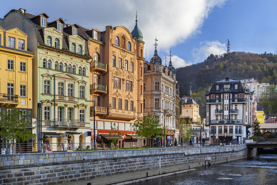 Tepla river in Karlovy Vary, Czech Republic. Wide angle view of the embankment near Atlantis hotel. Sunny day with blue sky