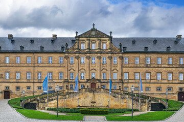 Fototapeta premium Banz Abbey in Bad Staffelstein, Germany. View of the historic baroque monastery building facade. Overcast cloudy day