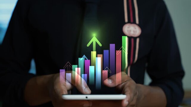 Hologram business graph bar glowing arrow on the screen with a man using a tablet, Business analytics growth chart on digital tablet