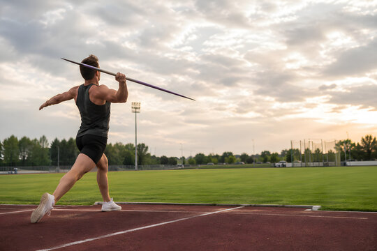 Male Javelin Athlete Preparing Throw on Outdoor Track and Field Stadium