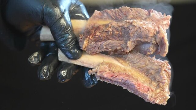 Hand lifting tender meat in galbitang