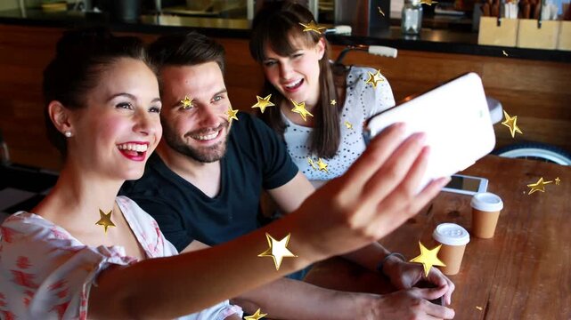 Three friends holding phone, posing and swiping selfies with star overlay moving for social media