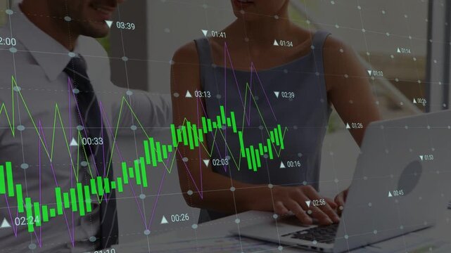 Woman typing, man noting at table, chart overlay shifting upward spurring lean and finance decision