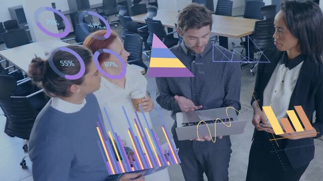 Team of four standing in open office reviewing business charts as man typing laptop updating rings