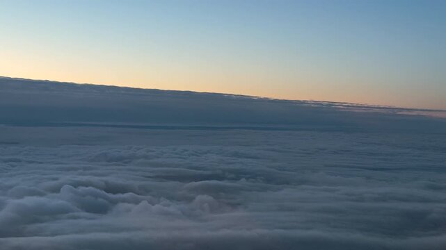 Aerial view of endless majestic stratocumulus cloud sea under the morning horizon.