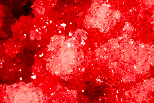 Amethyst red crystals. Gems. Mineral crystals in the natural environment. Texture of precious and semiprecious stones. Seamless background with copy space colored shiny surface of precious stones.