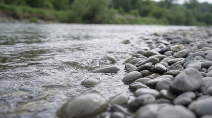 Fototapeta premium River water washing over smooth gray rocks. Nature background for environmental concept. Calm and peaceful outdoor scene.
