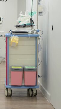 Vertical video: Moving camera revealing crash cart in X-RAY corridor, highlighting green mask