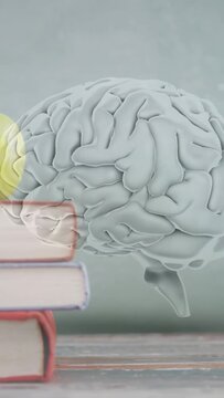 Vertical video: Books rising, causing 3D brain floating, yellow green glow expanding, showing study