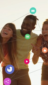 Vertical video: Trio laughing, leaning backlit, camera revealing sparking social icons for sharing