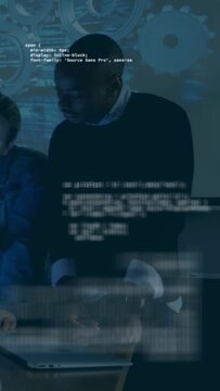 Vertical video: Man leaning and gesturing at laptop, causing code scrolling for tech review, gear