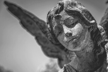 Naklejka premium Close up wonderful guardian angel. Fragment of an ancient stone statue.