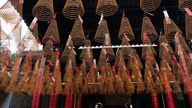 Traditional incense coils hanging from the ceiling of a vietnam buddhist temple. Symbolic offerings for prayer, luck, and remembrance, Ho Chi Minh city, Vietnam