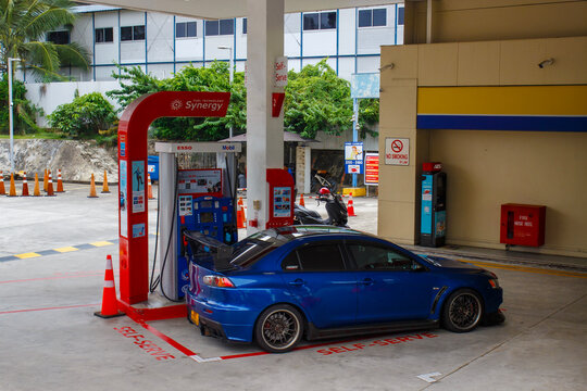 Singapore - 27 December, 2025: A blue Mitsubishi Lancer Evolution X car at a Esso Mobile gasoline station in Singapore