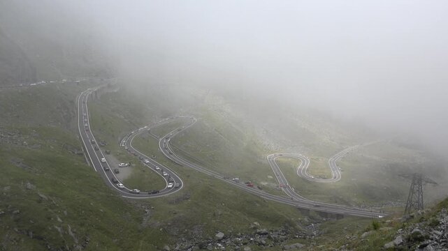 Car Traffic on Transfagarasan, Transalpine Roads in Romania, Mountains View Foggy Day