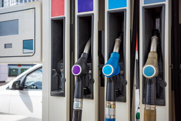 Fuel pump nozzles at modern gas station, close up refueling equipment detail. Concept: fuel prices © Marya