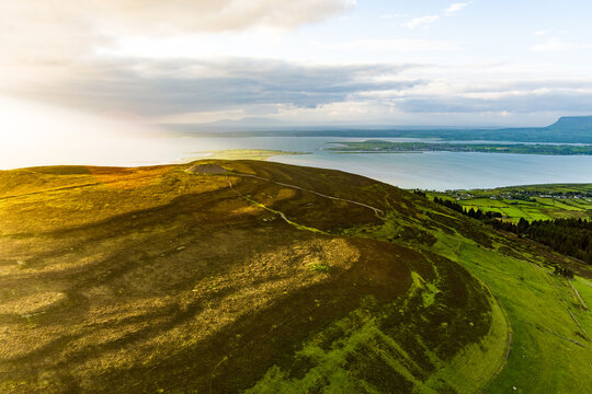 Aerial view of Queen Maeve Cairn on Knocknarea above the coast in County Sligo, Ireland. A prehistoric summit monument set in a dramatic Irish landscape.