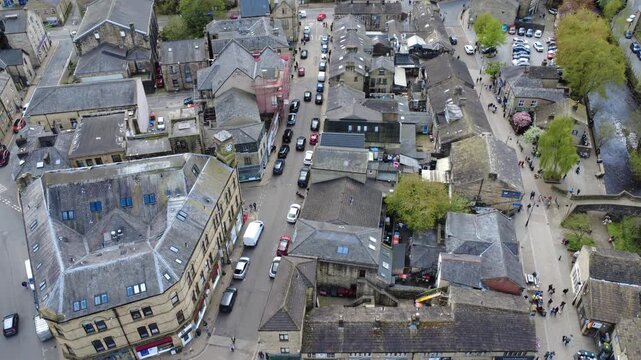 aerial drone view of Hebden Bridge town Centre in spring showing the main streets and park