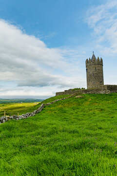 Doonagore Castle overlooking the Atlantic Ocean near Doolin, County Clare, Ireland. Historic 16th century tower house on the Wild Atlantic Way.