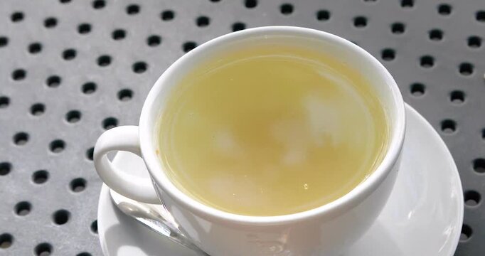 Hot ginger tea and the reflection of the sky in it in the morning. Good morning. Vigor and health.