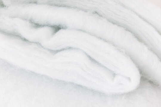 White Synthetic Padding Layer. Soft Polyester Batting Fiber Textile and Fabric Texture.