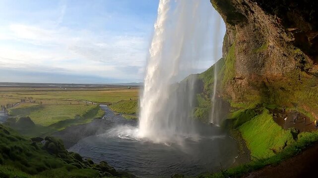 Epic side view of Seljalandsfoss waterfall and coastal plains, Iceland