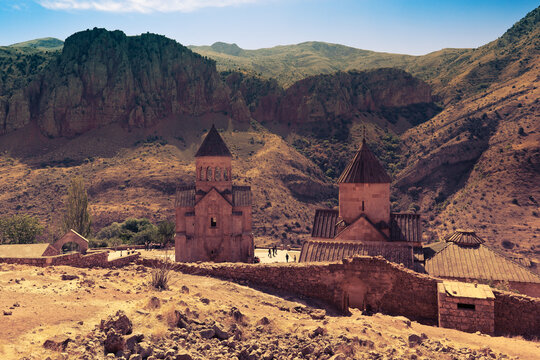 Tourists explore the Noravank - 13th-century monastic complex in mountain gorge of River Amaghu. Vayots Dzor Province, Armenia