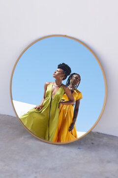 Fashion, mirror and black women outdoor with trendy clothes, modern style and elegant outfit. Confidence, beauty and African people with designer accessories, cosmetics and makeup in reflection