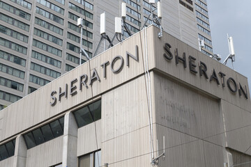 Fototapeta premium exterior building and sign of Sheraton Centre Toronto Hotel located at 123 Queen St (shown here northeast corner of York St and Richmond St W)
