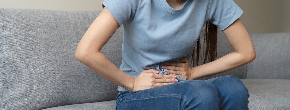 close up woman suffering stomach pain from food poisoning.