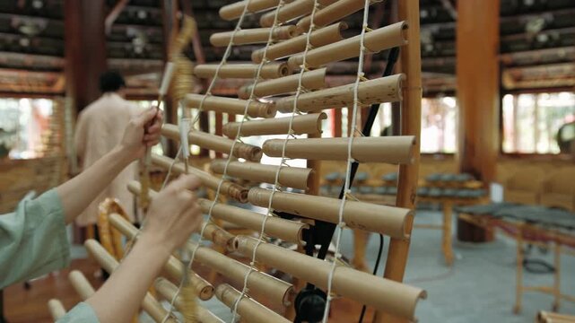 Musician playing traditional bamboo xylophone during a live performance